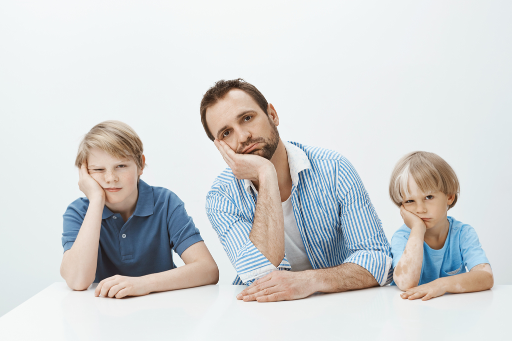 boys-feeling-bored-upset-portrait-tired-funny-european-family-sons-dad-sitting-table-leaning-heads-palms-staring-indifferent.jpg